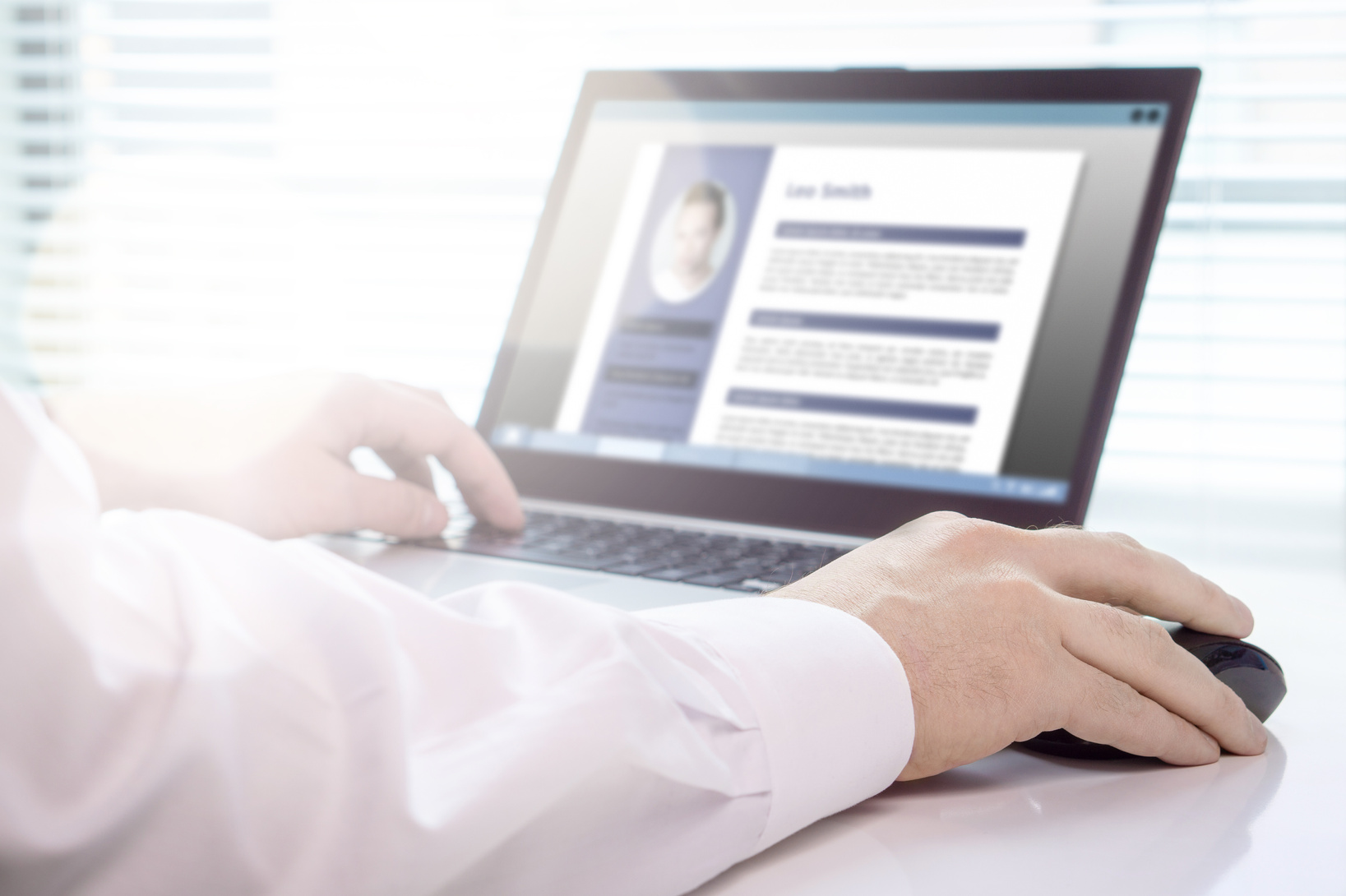 Job seeker and applicant writing his resume and CV with laptop. Modern and visual electronic curriculum vitae in social media. Work experience document in computer screen.